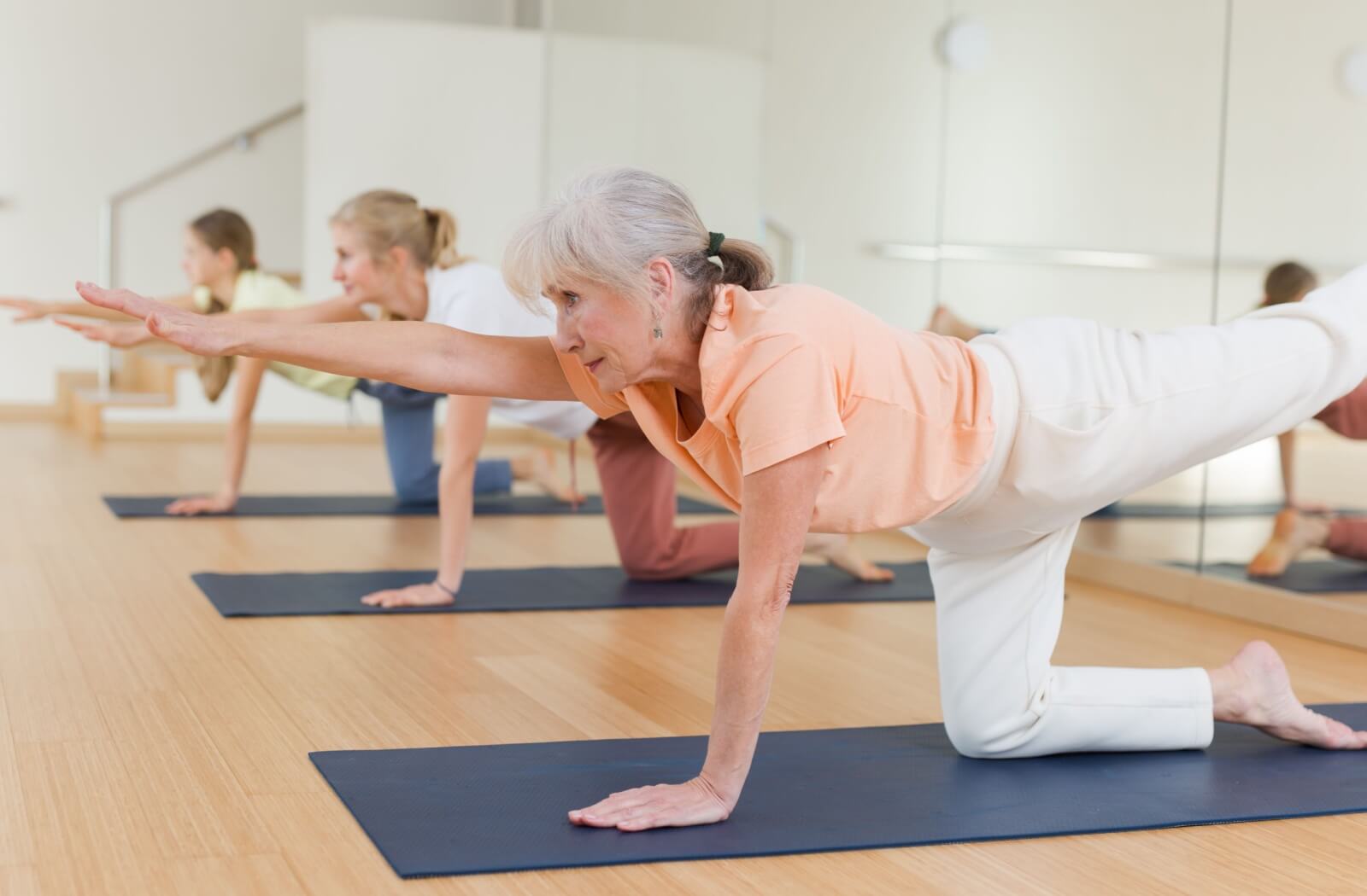 A group of seniors enjoying a yoga class at their senior living community