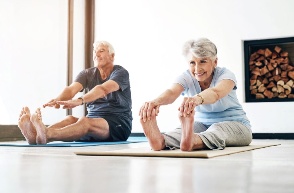 Two older adults practicing yoga together.
