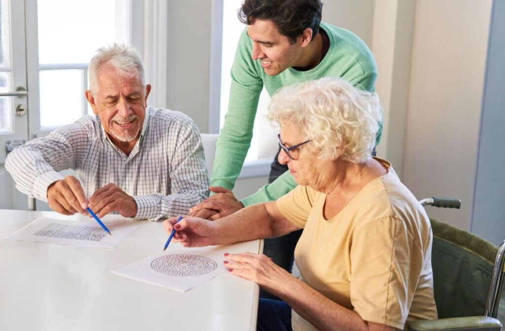Two older adults painting in a memory care community.